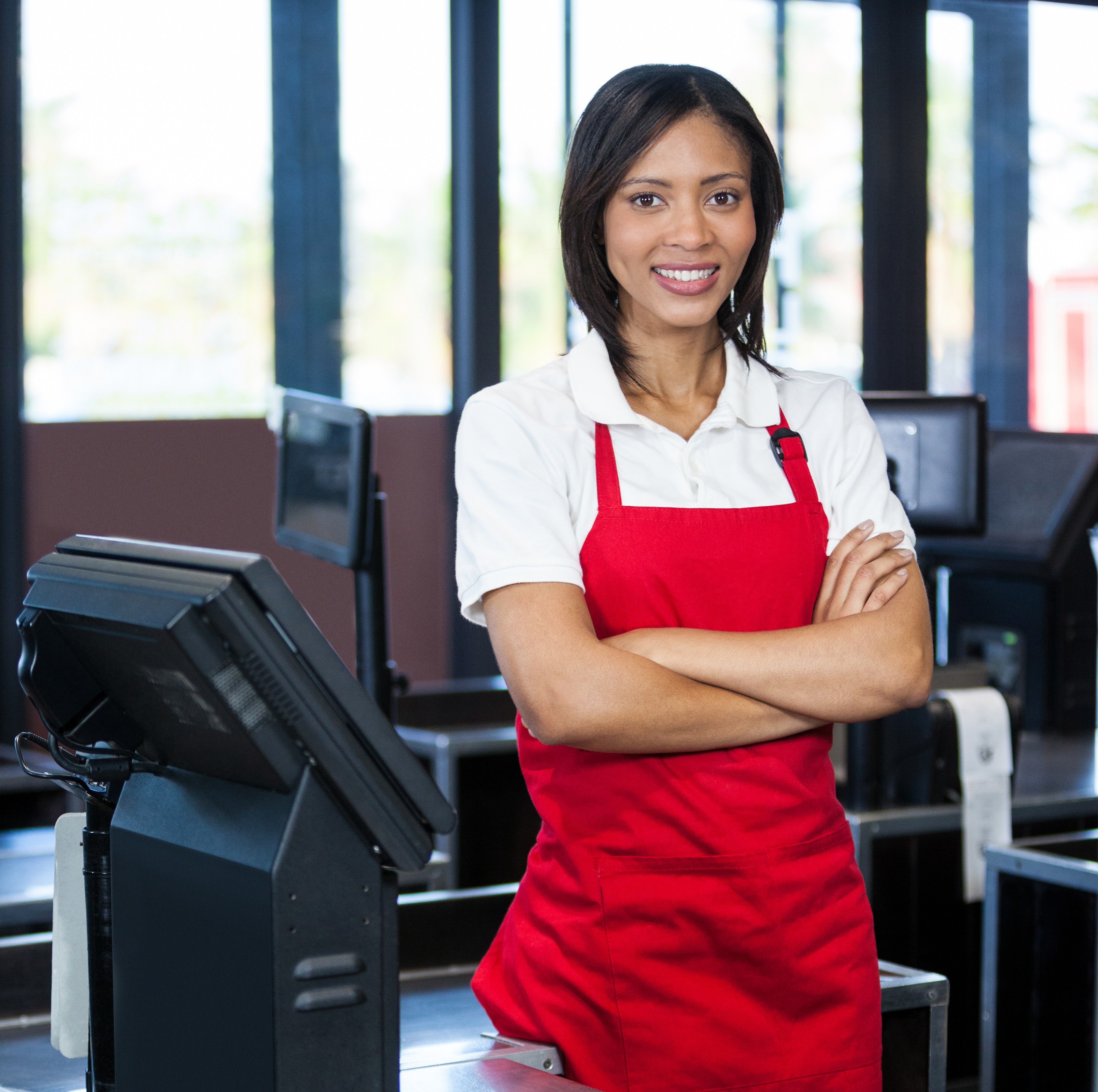 Image of a cashier standing on a retail floor mat.