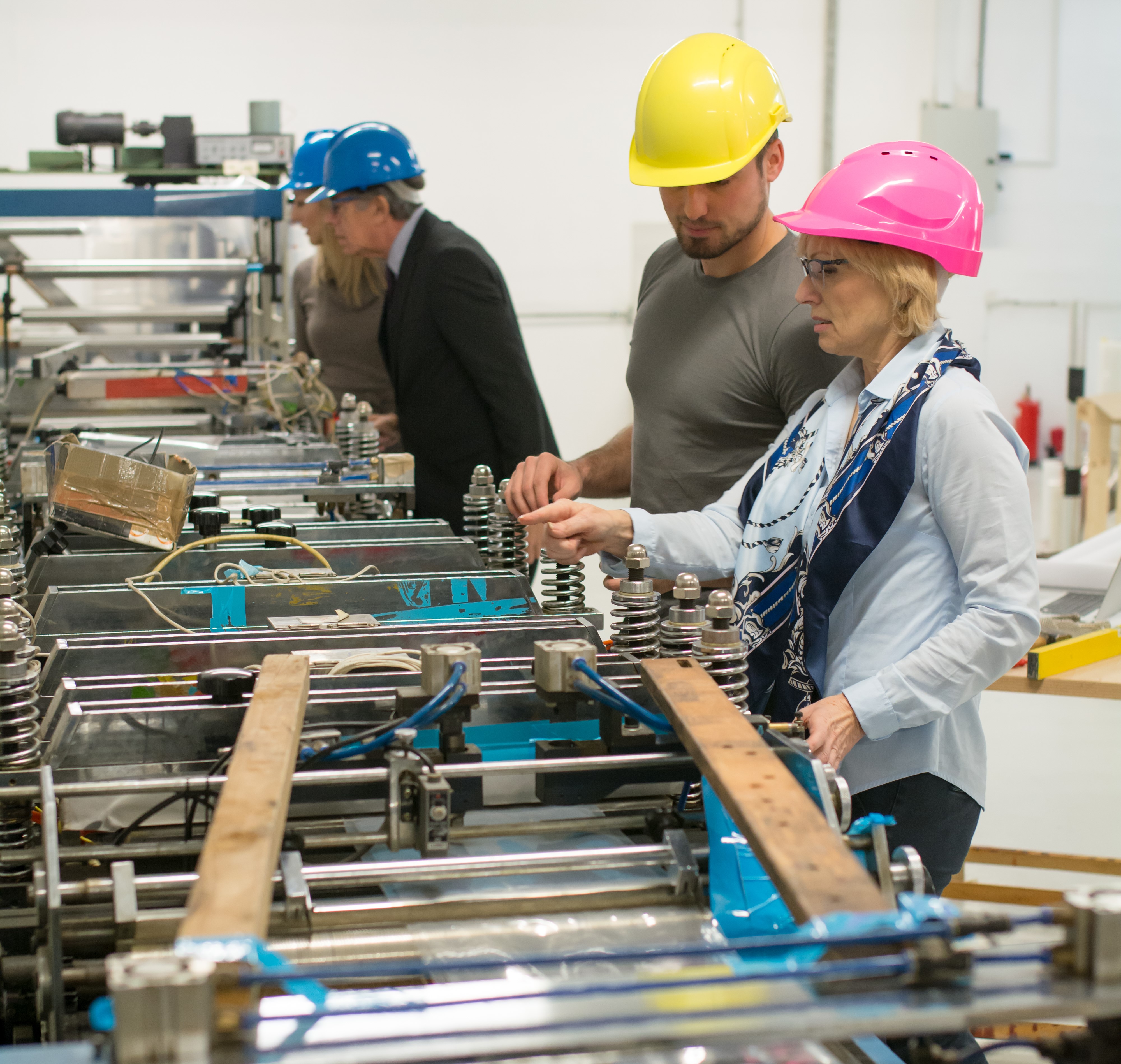 Image of employees using safety mats in a workspace.